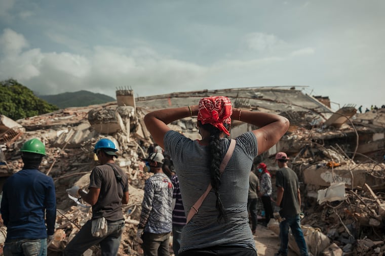 People look for their relatives in the rubble of a building collapsed by twin earthquakes in Caraballeda, Venezuela, July 4, 2026. Venezuelans are publicly expressing their anger over their government’s disaster response, despite the risk of imprisonment.