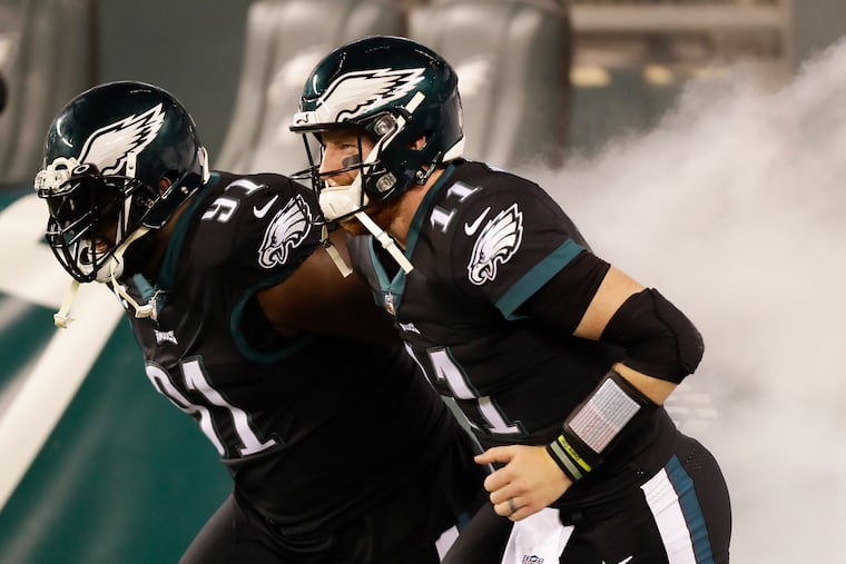 Carson Wentz and the Eagles face the rival Cowboys on Sunday night and aim to remain atop the NFC East standings.