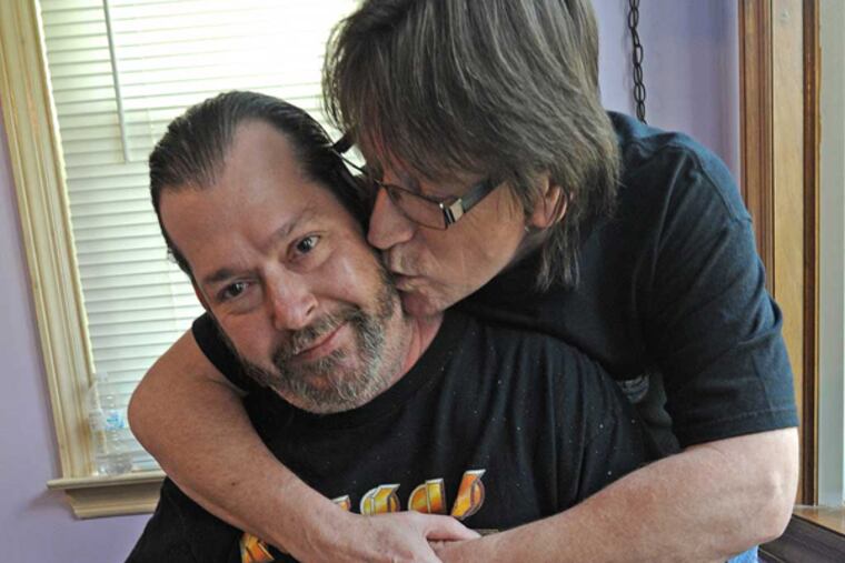 At their Norristown home, Matthew Mionczynski, seated, and David Soppick. (APRIL SAUL / Staff)