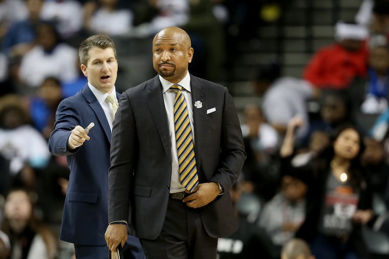 La Salle coach Ashley Howard walks onto the court for a timeout during his team's second-round Atlantic 10 Tournament game against Rhode Island.