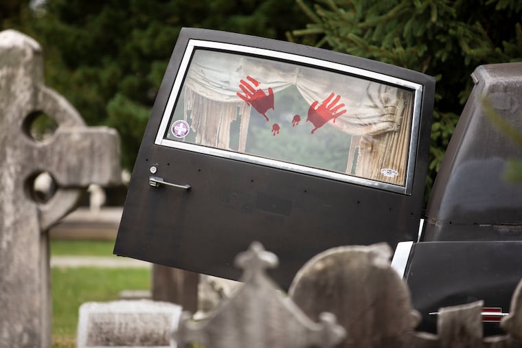 Fake bloody handprints decorate a hearse window during the 13th Car & Hearse Show presented by the Mohnton Professional Car Club at Laurel Hill Cemetery in Philadelphia, Pa., on Sunday, August 1, 2021. The show included hearses, flower cars, ambulances and limousines. The 70-member club awards custom made trophies in a variety of categories during the show.