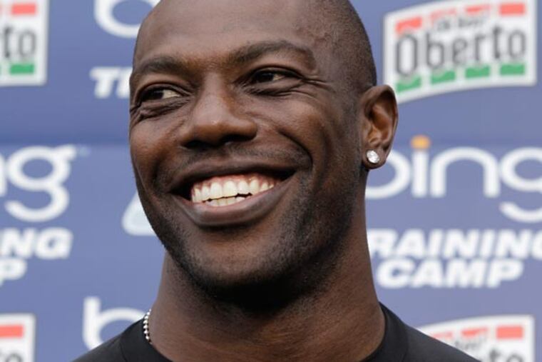Terrell Owens smiles during NFL football training camp in Renton, Wash. Both Owens and San Francisco 49ers wide receiver Randy Moss are both determined to return to their dominating deep threats they were in their primes. (Ted S. Warren/AP file)