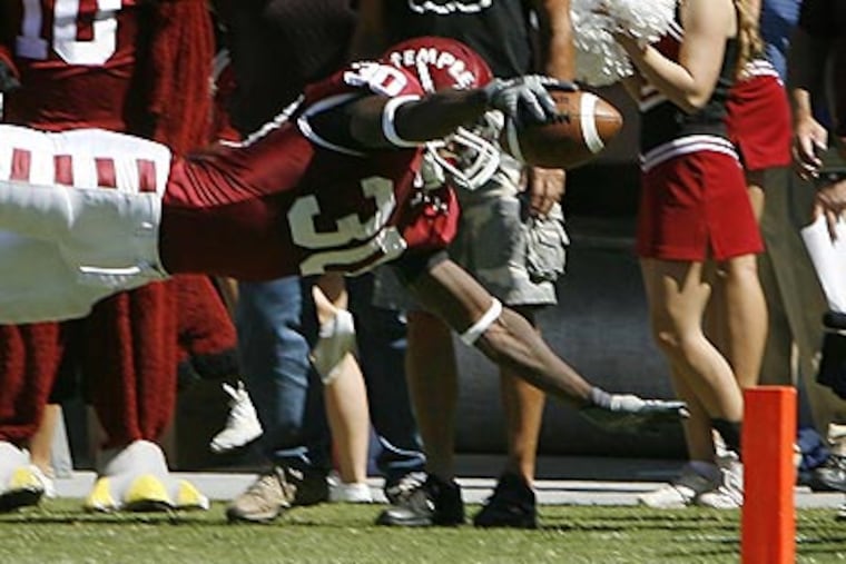 Bernard Pierce dives for one of his four touchdowns. (Michael S. Wirtz/Staff Photographer)