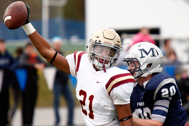 Haverford School receiver Keyveat Postell celebrates as he scores the Fords' first touchdown, a 13-yard reception, against Malvern Prep. Defending is the Friars' Dan Sullivan. Haverford went on to win, 31-14, Saturday (10/24/15) in an Inter-Ac League football game at Malvern. (LOU RABITO / Staff)