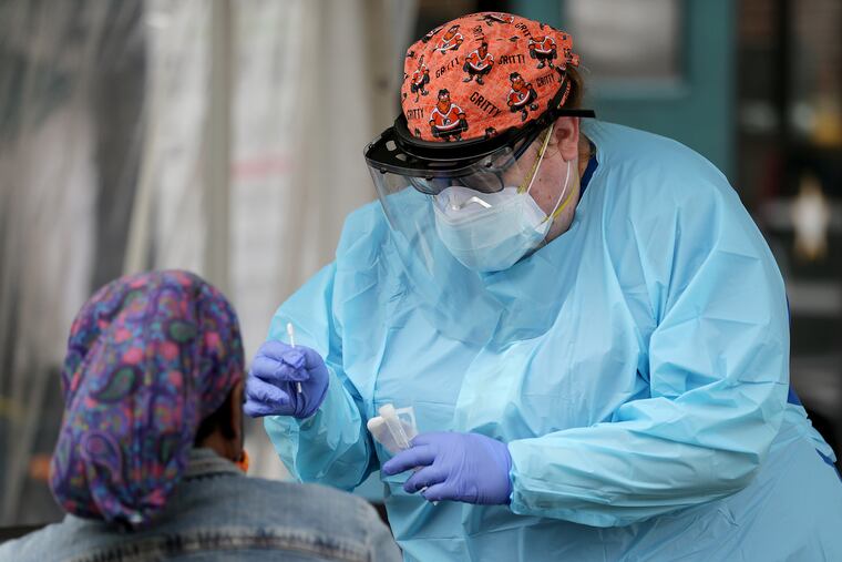 Nurse Julia Henessey (right) takes the swab from Janice Mason at the new Jefferson St. Raymond COVID-19 test site funded by Philadelphia, run by Jefferson Health at St. Raymond of Penafort Church in Philadelphia on October 1.