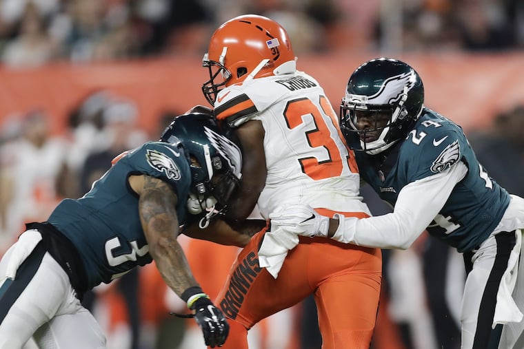 Tre Sullivan (left) and Corey Graham go after Browns running back Nick Chubb during a preseason game. Tackles are being closely watched as part of the NFL's new helmet-hit rule.