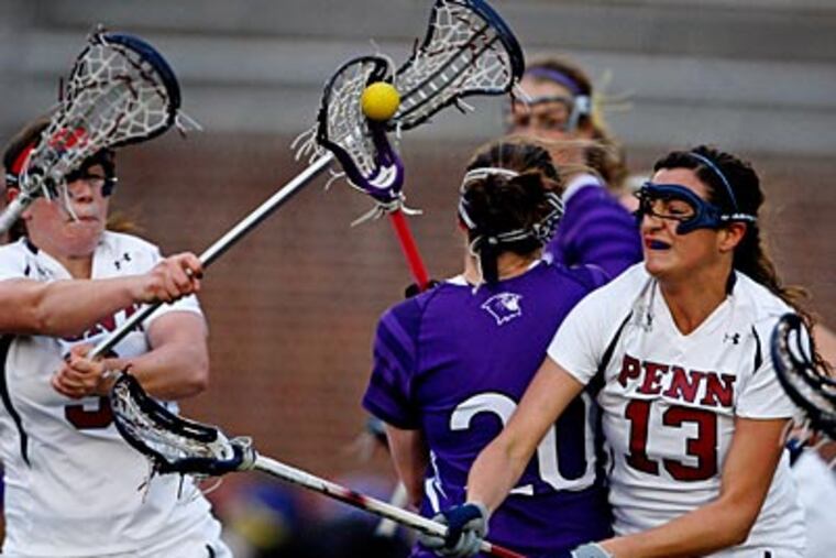 Penn's Courtney Lubbe, left, and Giulia Giordano put pressure on Northwestern's Maggie Bremer. (Ron Cortes / Staff Photographer)