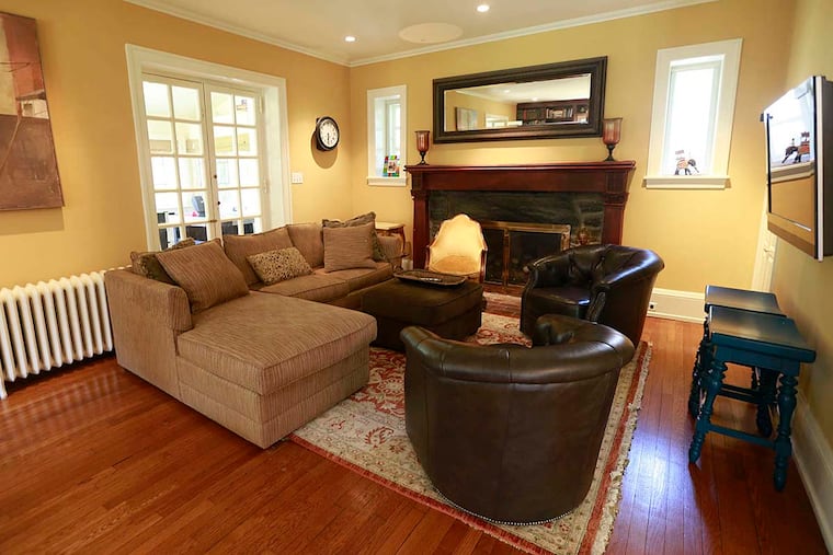 Mark Alter and Margi Shah's golden living room features shades of brown with walnut accents and beige seating.