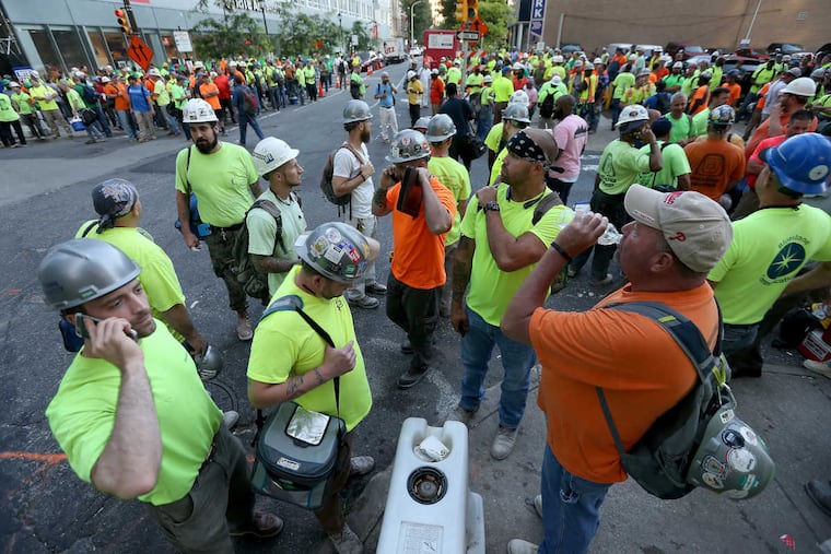 Union workers gather outside the construction site as union crane operators protest in front of the Comcast tower in Philadelphia, PA on June 30, 2017.