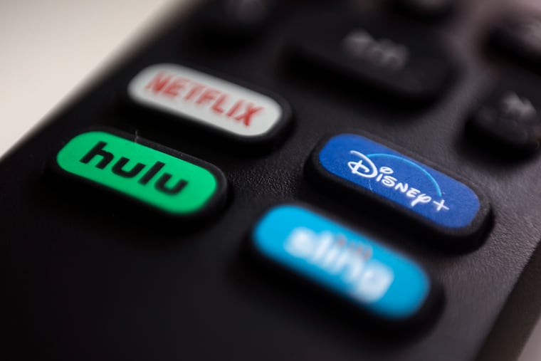 The logos for streaming services Netflix, Hulu, Disney Plus and Sling TV are pictured on a remote control in 2020 in Portland, Ore.