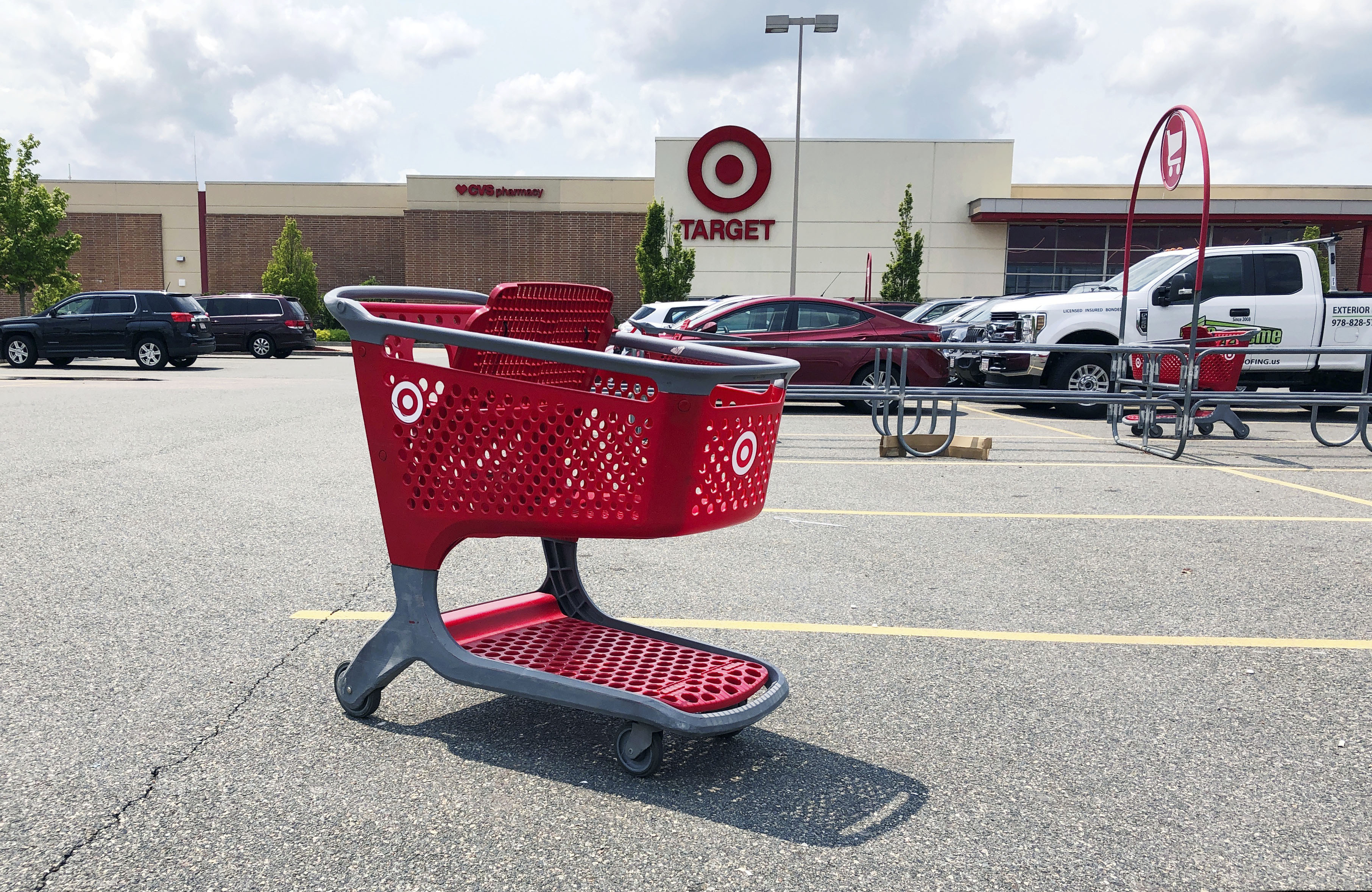 In this June 3, 2019, file photo a shopping cart sits in the parking lot of a Target store in Marlborough, Mass. (AP Photo/Bill Sikes, File)