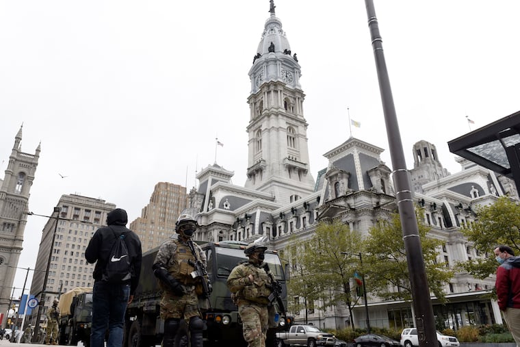 Members of the Pennsylvania National Guard patrol in front of City Hall, Friday, Oct. 30, 2020, in Philadelphia. (AP Photo/Michael Perez)