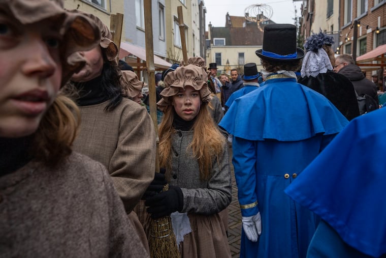 People in costumes from Charles Dickens' 19th-century English era take part in a Dickens Festival, in Deventer, Netherlands, Saturday, Dec. 14, 2024. His work and that of other 19th-century authors can teach us a lot about public health. (AP Photo/Peter Dejong)