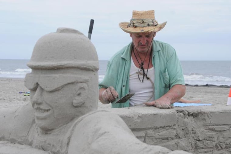 John Gruber works on a sand sculpture on the 7th St. beach in Ocean City, a promotion for NJ American Water. Photo / Curt Hudson