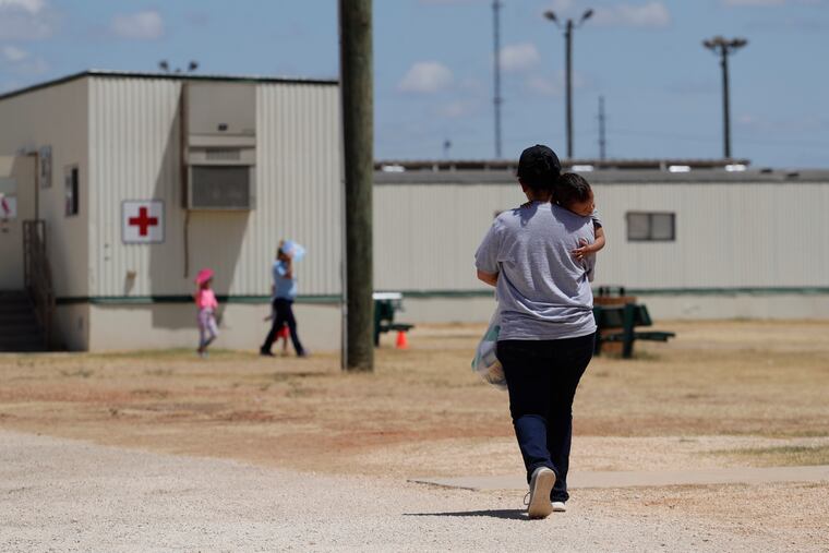 Immigrants seeking asylum walk at the ICE South Texas Family Residential Center, in Dilley, Texas. A federal judge on Wednesday, Nov. 18, 2020, ordered the Trump administration to stop expelling immigrant children who cross the southern border alone, halting a policy that has resulted in thousands of rapid deportations of minors during the coronavirus pandemic.