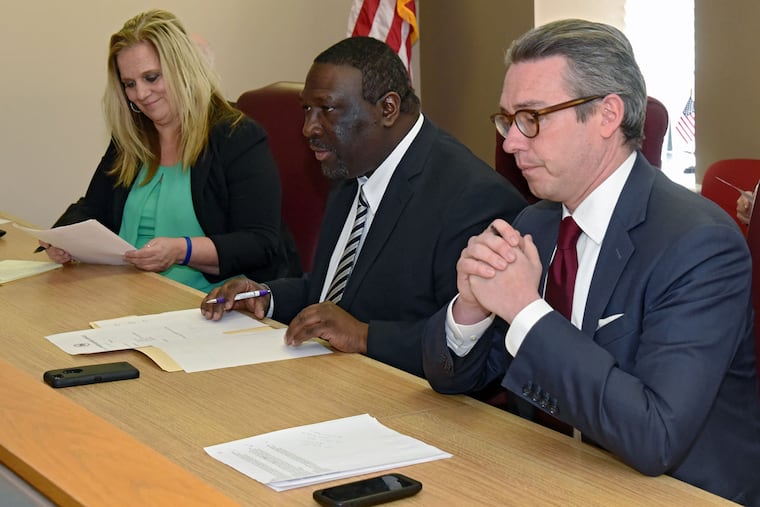 Anthony Clark, flanked by his fellow members of the City Commissioners, Lisa Deeley and Al Schmidt.