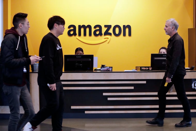 Employees walk through a lobby at Amazon's headquarters in Seattle in 2018.