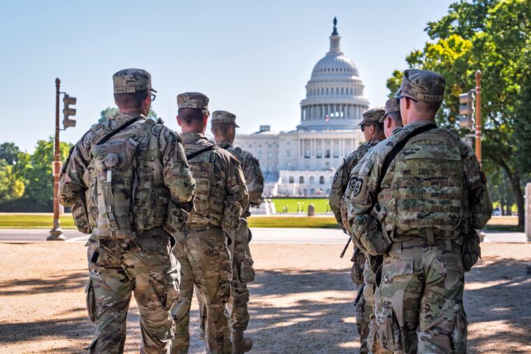 Armed National Guard soldiers patrol near the Capitol in Washington as part of President Donald Trump's order to impose federal law enforcement in the District of Columbia.