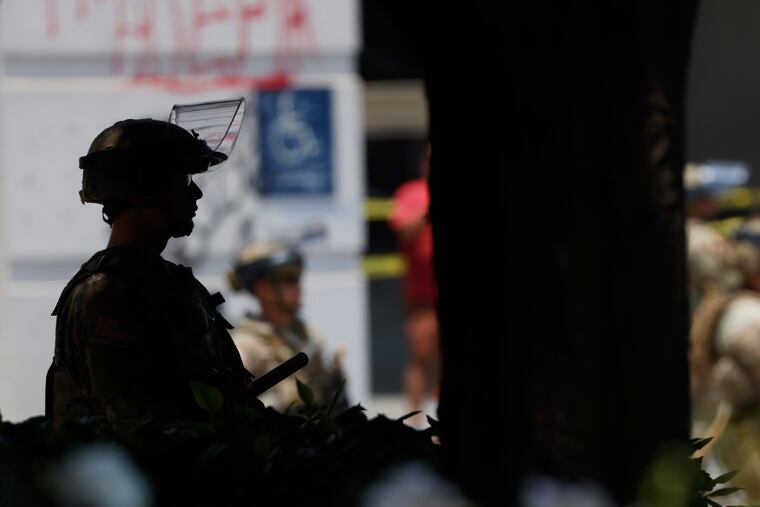 National Guard members assemble near the Metropolitan Detention Center in Los Angeles on Thursday.