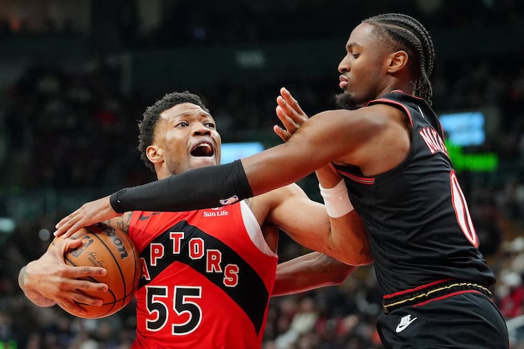 Sixers' Tyrese Maxey (right) defends Raptors guard Alijah Martin during the second half of Sunday's game in Toronto.
