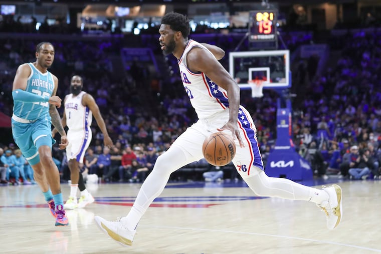 Philadelphia 76ers center Joel Embiid (21) handles the ball in the first quarter of a game against the Charlotte Hornets at the Wells Fargo Center in Philadelphia on Saturday, April 2, 2022.