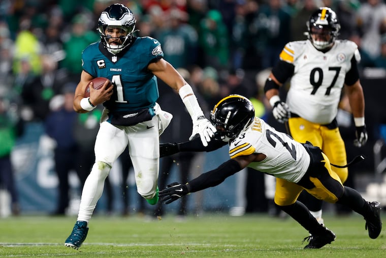 Philadelphia Eagles quarterback Jalen Hurts runs past Pittsburgh Steelers safety Damontae Kazee during the third quarter of the game on Sunday, Dec. 15, 2024, at Lincoln Financial Field in Philadelphia.