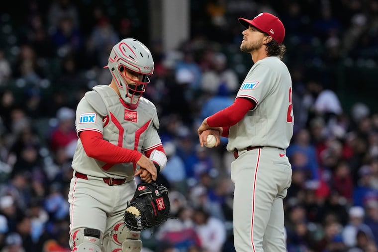 Phillies pitcher Aaron Nola (right) allowed six hits and five earned runs in 4⅓ innings on Monday.