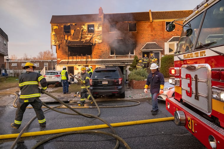 Philadelphia fire department at scene of row house fire that started on the 3300 block of Kayford Circle in Morrell Park on Tuesday morning. The fire destroyed three rowhouses and sent five people to hospital.