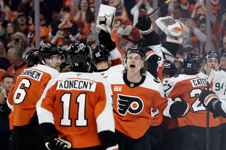 Trevor Zegras celebrates with teammates after the Flyers beat the Carolina Hurricanes in a shootout on Monday to clinch a playoff berth.