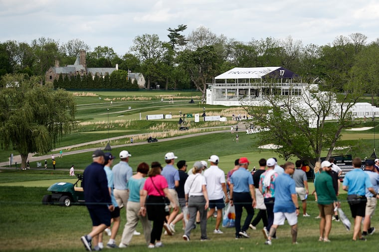 Spectators walk along the fairway during the Creator Classic event at the Truist Championship at the Philadelphia Cricket Club Wissahickon Course on Wednesday. Friday may not be as pleasant.
