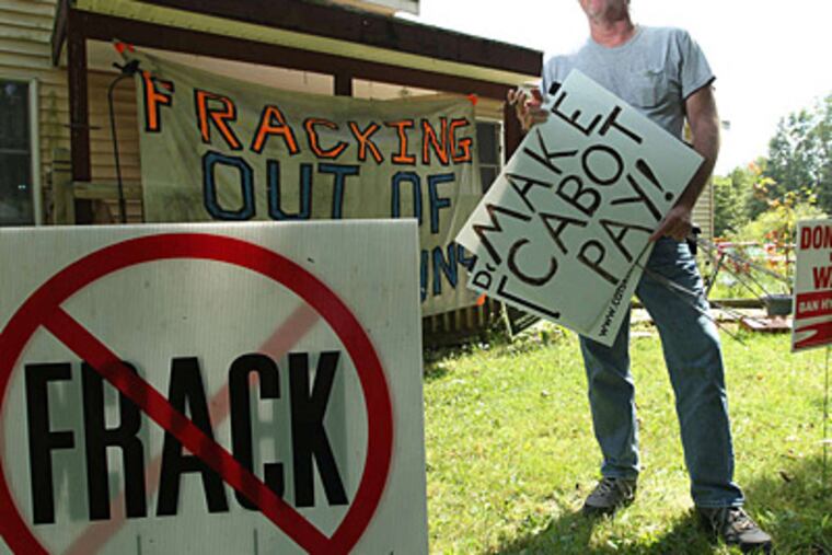 Raymond D. Kemble in his front yard. Above, water from his well, which he claims is still polluted by drillers. (Michael Bryant/Staff)