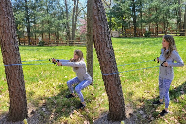 Ashley demonstrates a squat row.