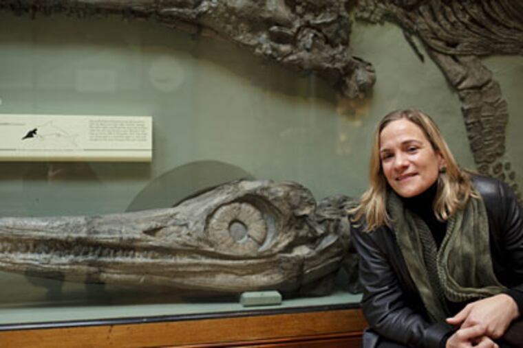Tracy Chevalier poses next to a plesiosaur fossil, discovered by the subject of her latest book, "Remarkable Creatures," at the Natural History Museum in central London. (AP Photo/David Azia)