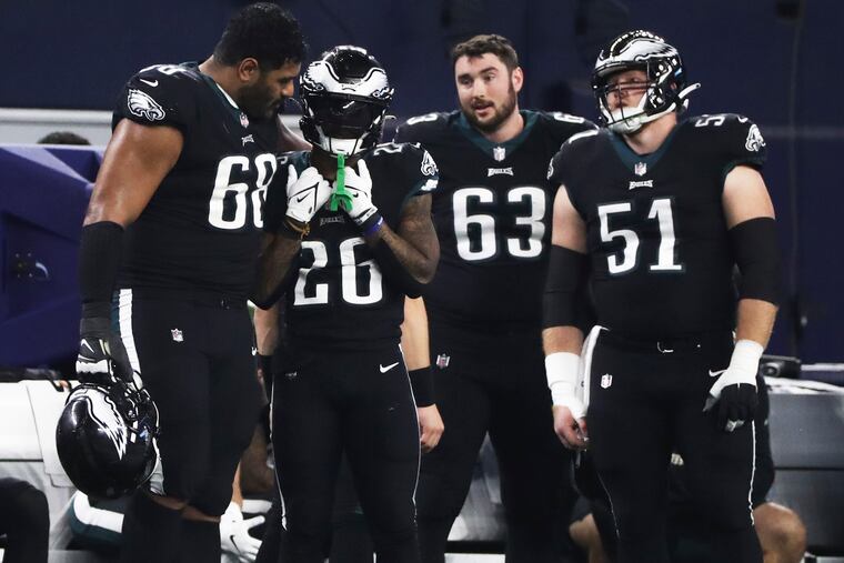 Philadelphia Eagles running back Miles Sanders (26) is consoled by Philadelphia Eagles offensive tackle Jordan Mailata (68) after Sanders fumbled the ball in the fourth quarter of a game against the Dallas Cowboys at AT&T Stadium in Arlington, Tx. on Saturday, Dec. 24, 2022. Dallas won, 40-34.