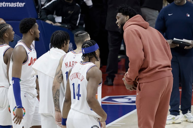 Joel Embiid (right) has missed all but 13 of the Sixers' games this season.