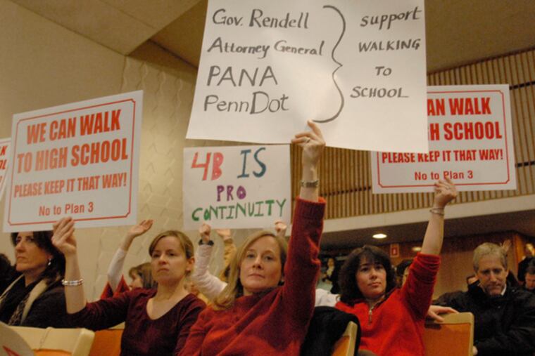 Among those holding signs opposing the Lower Merion district's busing plan are Elyse Seltzer (center) and Janet Long (left).