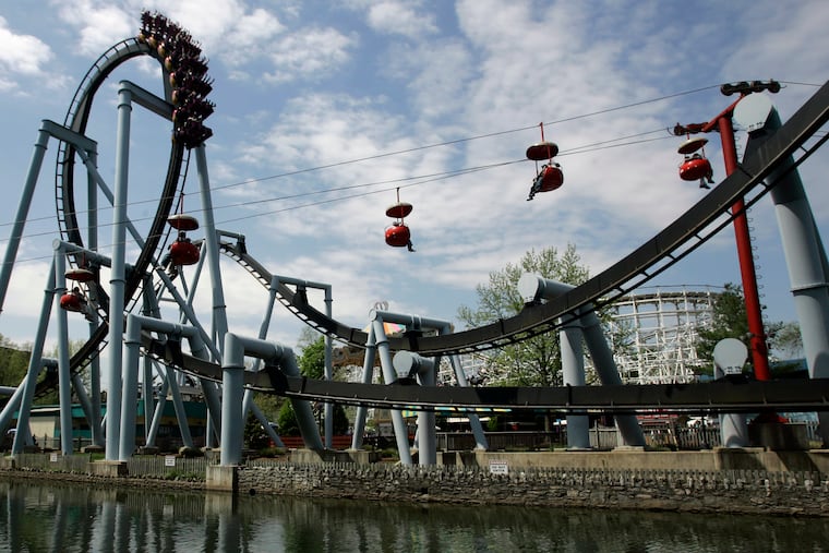In this file photo, the Great Bear, an inverted roller coaster, and the Skyview ride are seen at Hersheypark in Hershey, Pa.