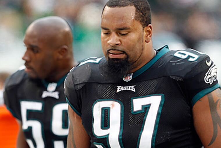 Cullen Jenkins walks to the bench after the Falcons scored a first quarter touchdown. (Yong Kim/Staff Photographer)