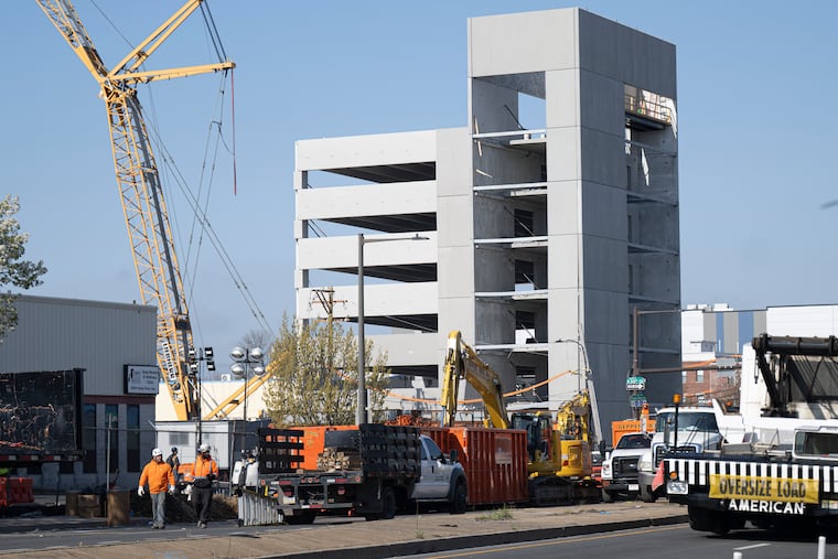 Cranes arrive as city workers prepare to deconstruct and demolish the collapsed parking garage in Grays Ferry on Friday.