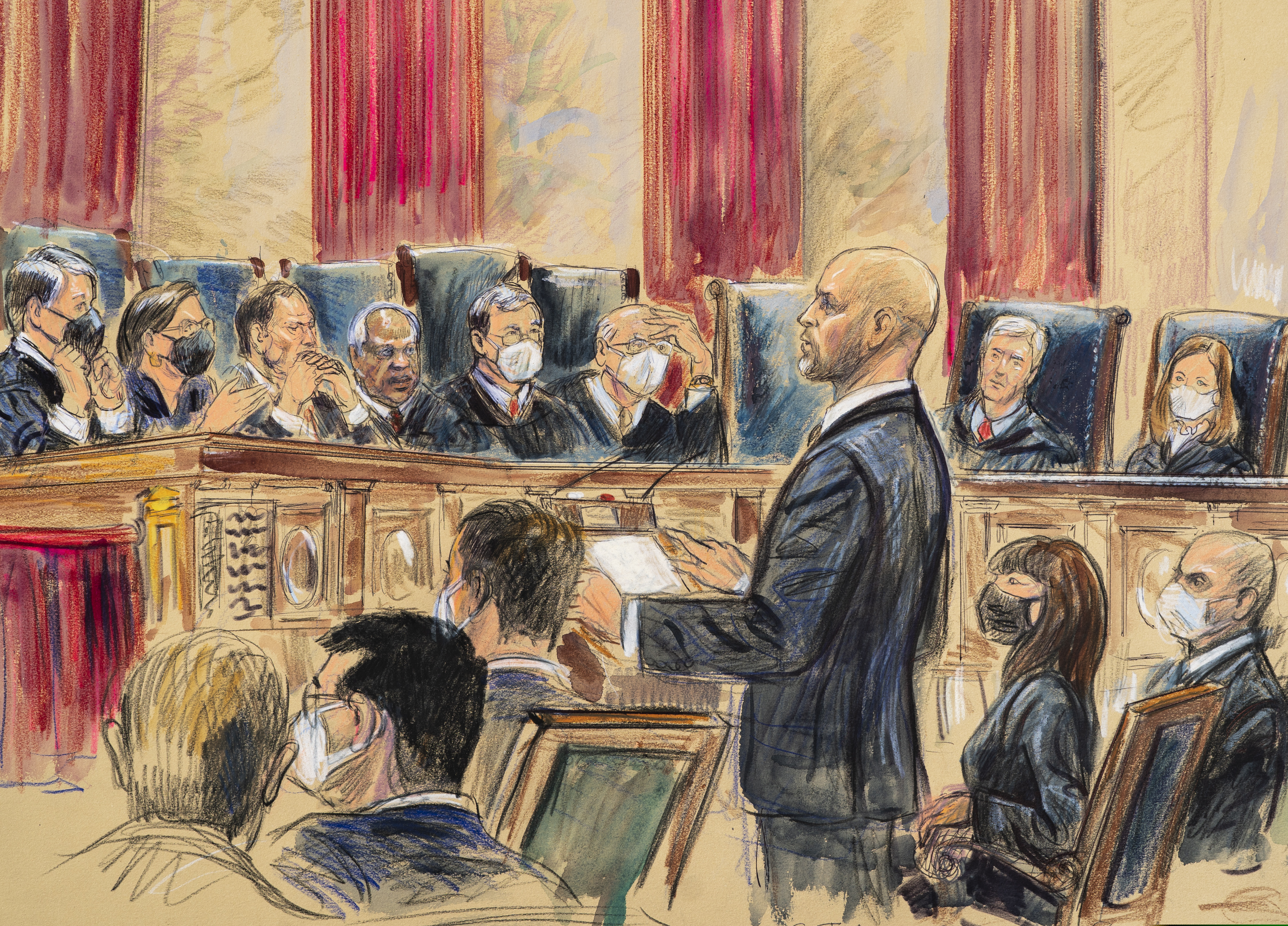 This artist sketch depicts lawyer Scott Keller standing to argue on behalf of more than two dozen business groups seeking an immediate order from the Supreme Court to halt a Biden administration order to impose a vaccine-or-testing requirement on the nation's large employers during the COVID-19 pandemic, at the Supreme Court in Washington.