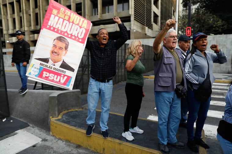 Supporters display a poster of Venezuelan President Nicolás Maduro in Caracas, Venezuela, Saturday, Jan. 3, 2026, after U.S. President Donald Trump announced Maduro had been captured and flown out of the country.