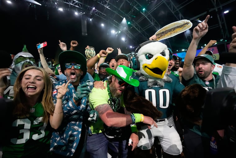 Eagles fans celebrate with Swoop during the first round of the NFL draft, Thursday in Pittsburgh.