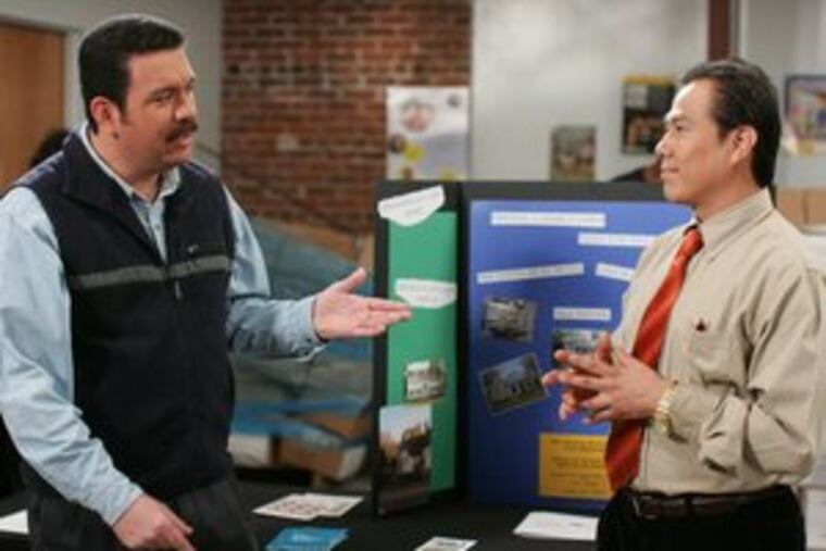 Miguel Sanchez (Miguel Chirinos, left) seeks advice on financial matters from the housing counselor in an episode of "Nuestro Barrio."