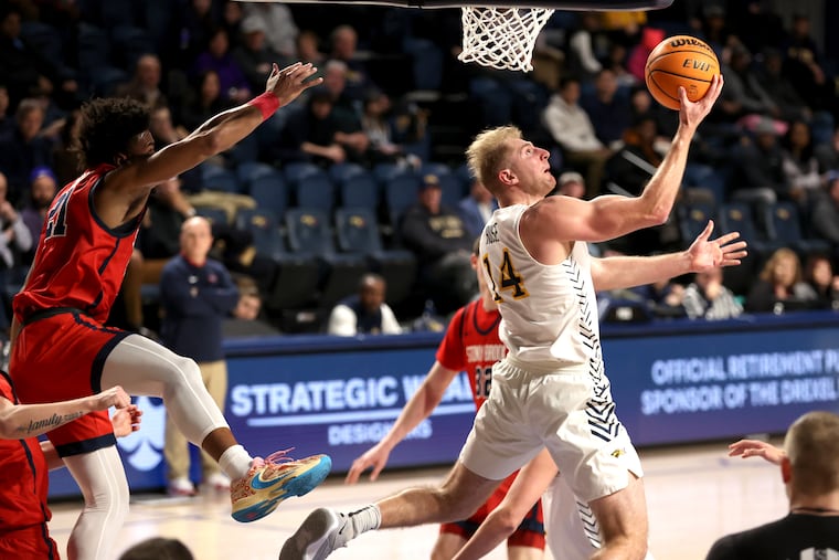 Luke House, right, of Drexel goes up for.a reverse layup against Stony Brook during the first half on Feb. 29, 2024.