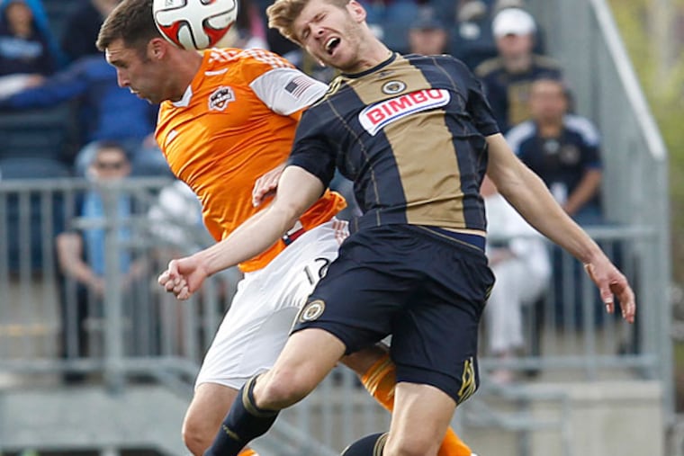 Union's Aaron Wheeler (right) goes for a header next to Dynamo's Will Bruin. (Ron Cortes/Staff Photographer)