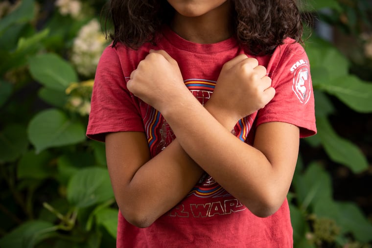 Titus Scarpelli, 10, posed for a portrait while making the Black Panther pose near his home in Philadelphia on Thursday, November 11, 2021.