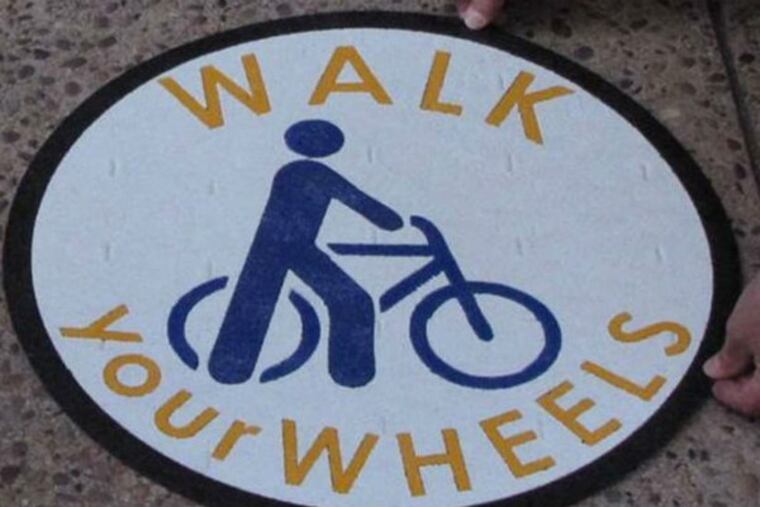 Riding a bike on the sidewalk is illegal. Here's a sign of the times.