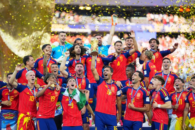 Spain celebrates with the World Cup trophy after defeating Argentina in extra time of the final in East Rutherford, N.J., on Sunday.