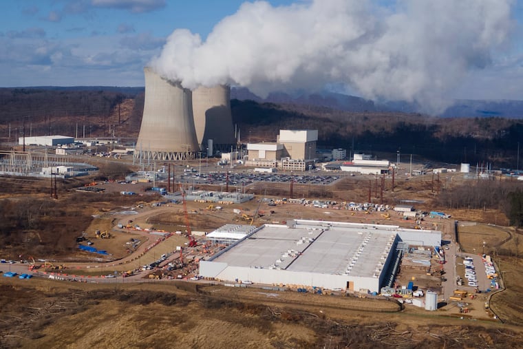 A data center owned by Amazon Web Services, front right, is photographed while under construction next to the Susquehanna nuclear power plant in Berwick, Pa. in January 2025.