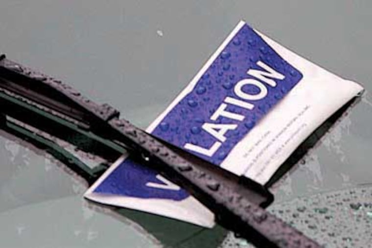 A blue and white violation and envelope left by Parking Authority Officer Ray Reichner while patrolling on Walnut near 6th in Center City. ( John Costello / Inquirer ) Editor Note 97530 PPA28 Friday 10-25-07